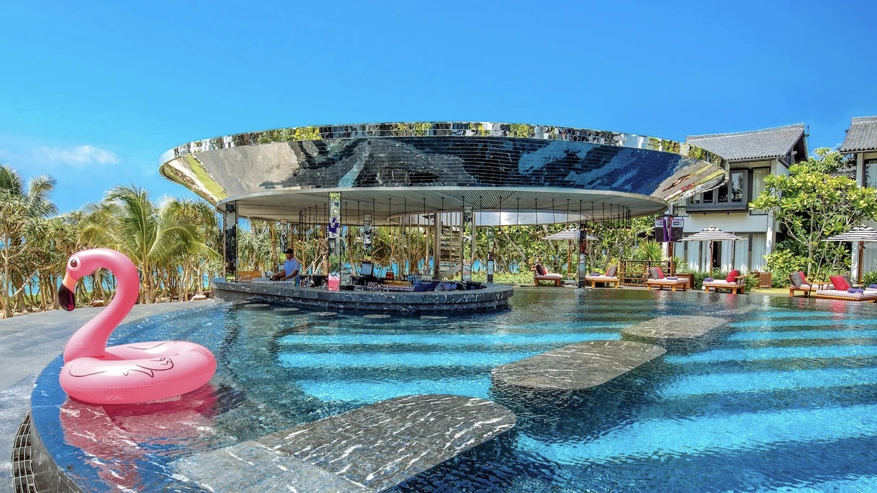 outside bar near the pool and a flamingo floating at baba beach club