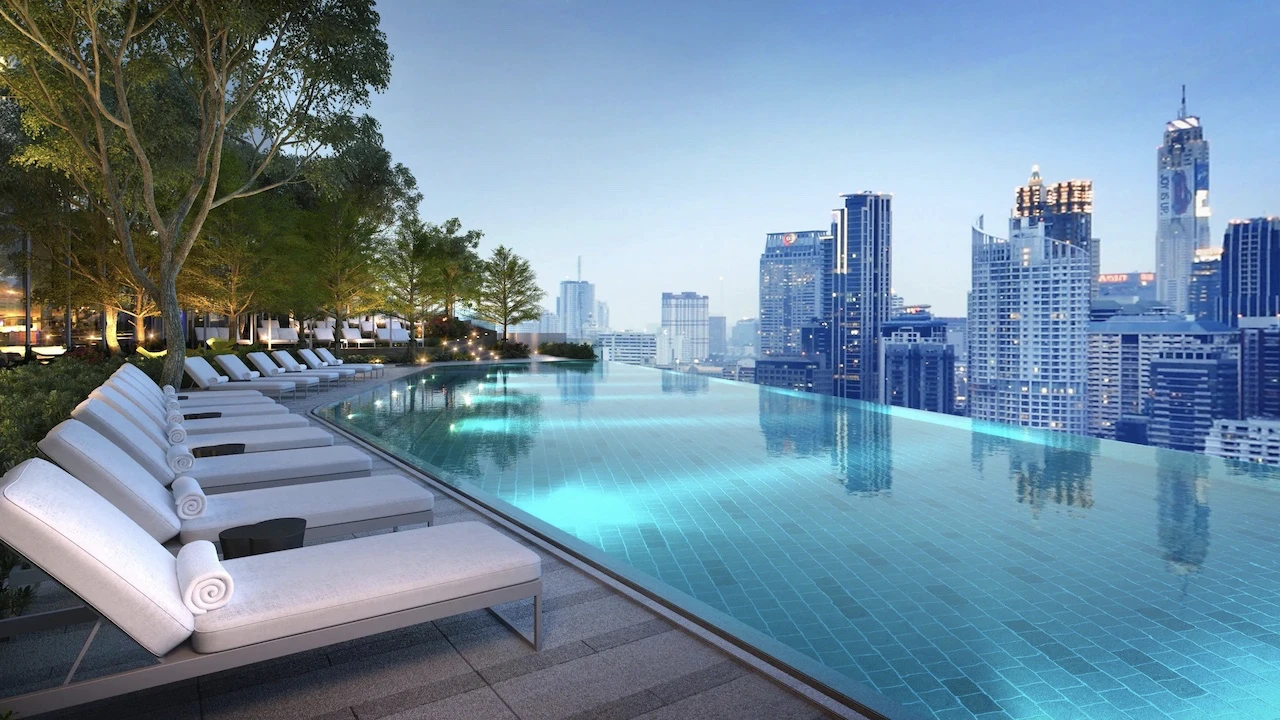 pool side with long chairs and view on city of bangkok at park hyatt hotel