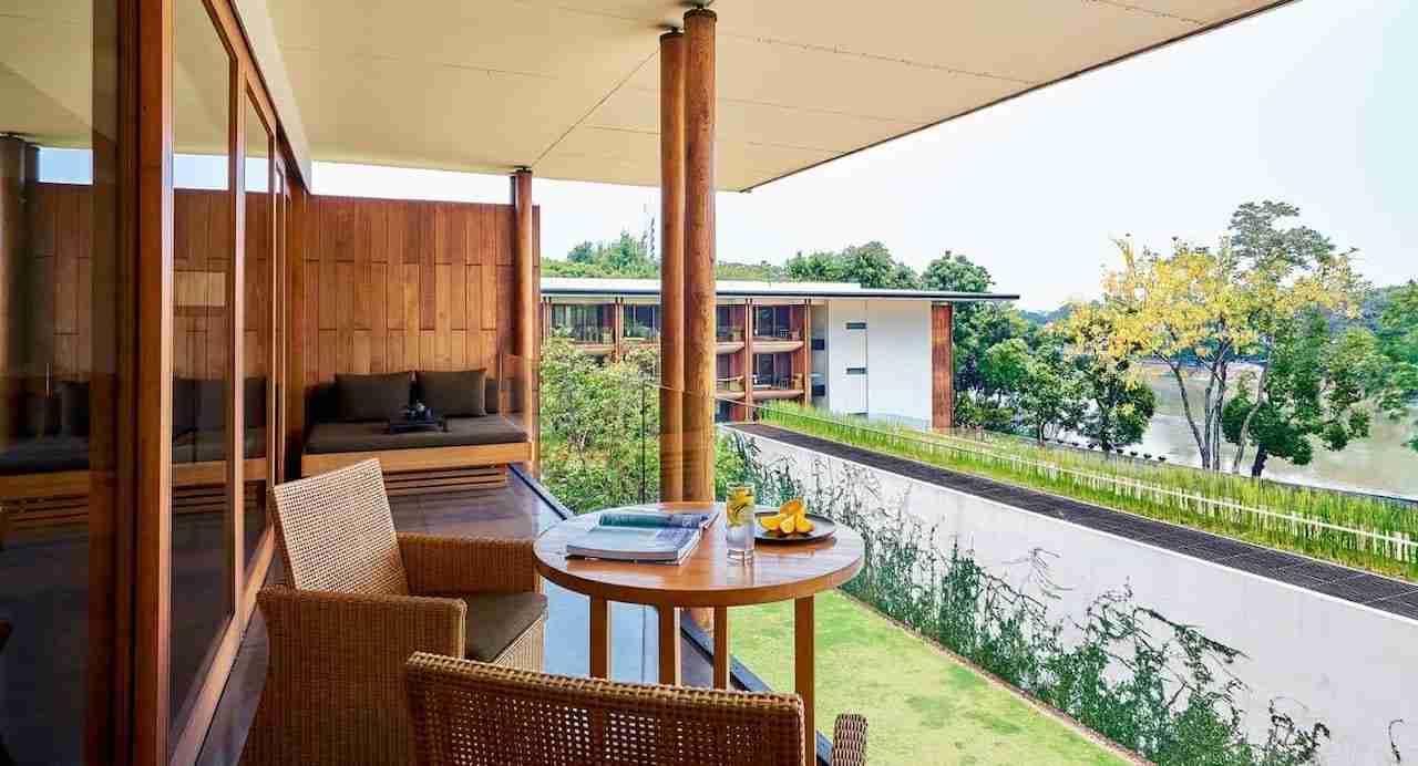 balcony of a suite with river view at Anantara Chiang Mai Kasara in Thailand