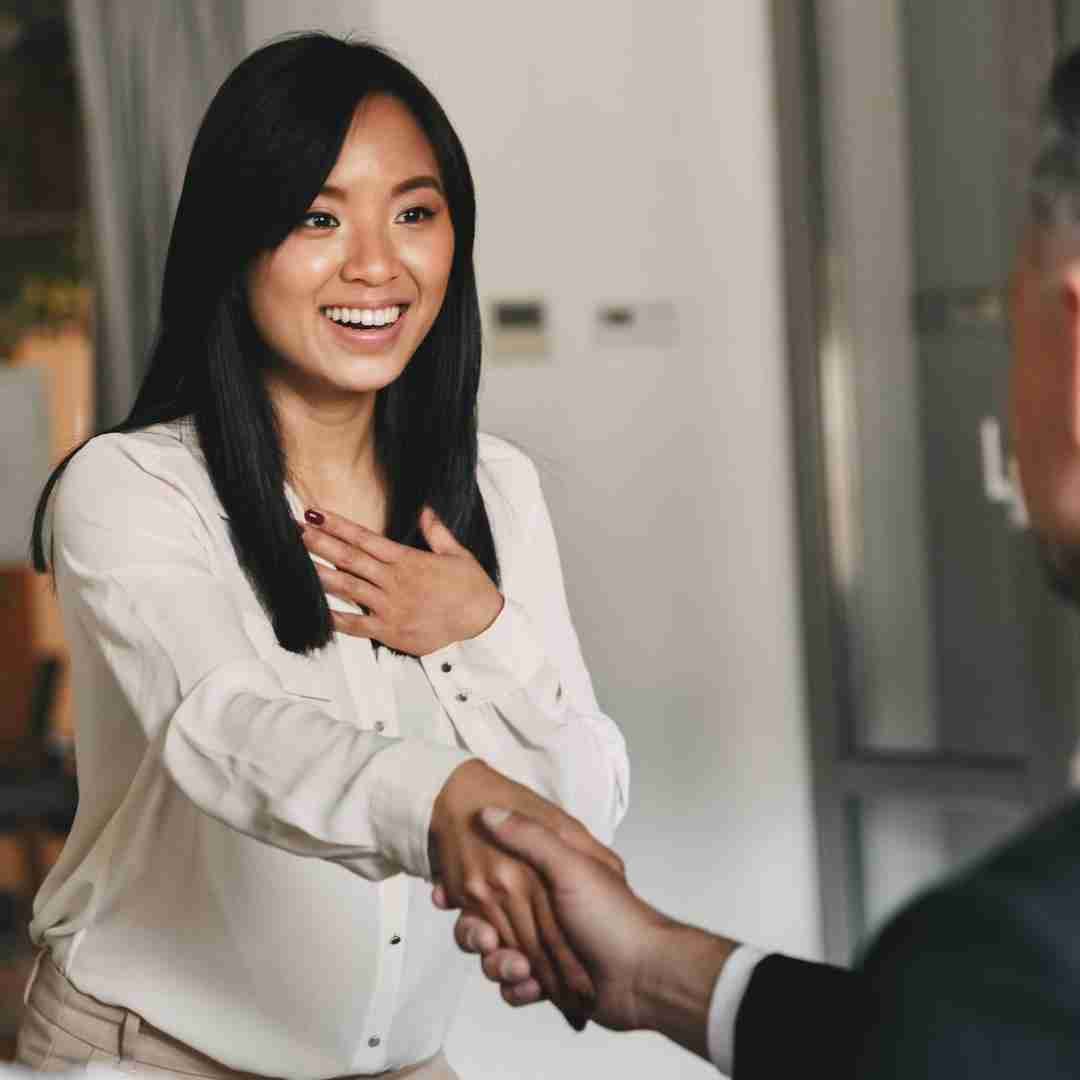 asian legal assistant shaking the hand of a client