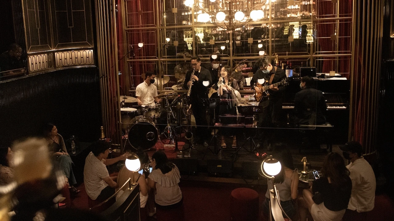 a woman singing during a live music event at crimson room cocktail bar in bangkok