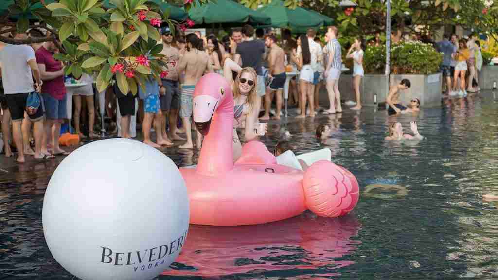 bikini girl on a floatable at epic pool party in Bangkok