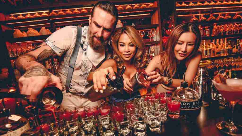bartender and sexy Thai girls making cocktails at a bar in Bangkok