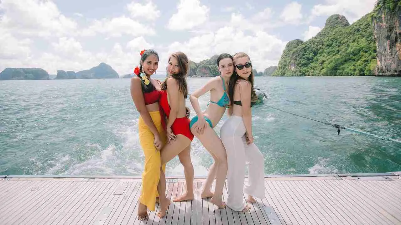 beautiful girls on a the deck of a boat party in Phuket Thailand