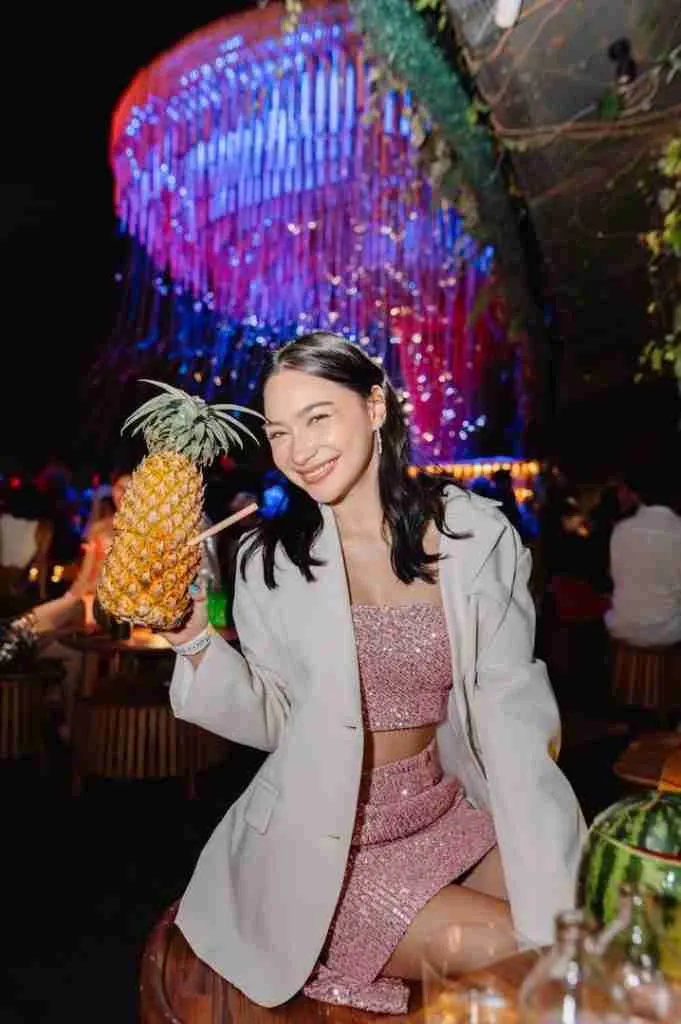 beautiful Thai girl drinking cocktail at Tichuca rooftop bar in Bangkok