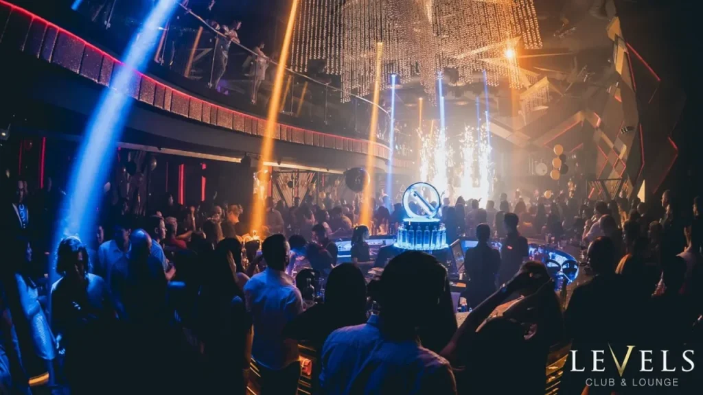 the large room of levels club bangkok with mezzanine and a concert in the background