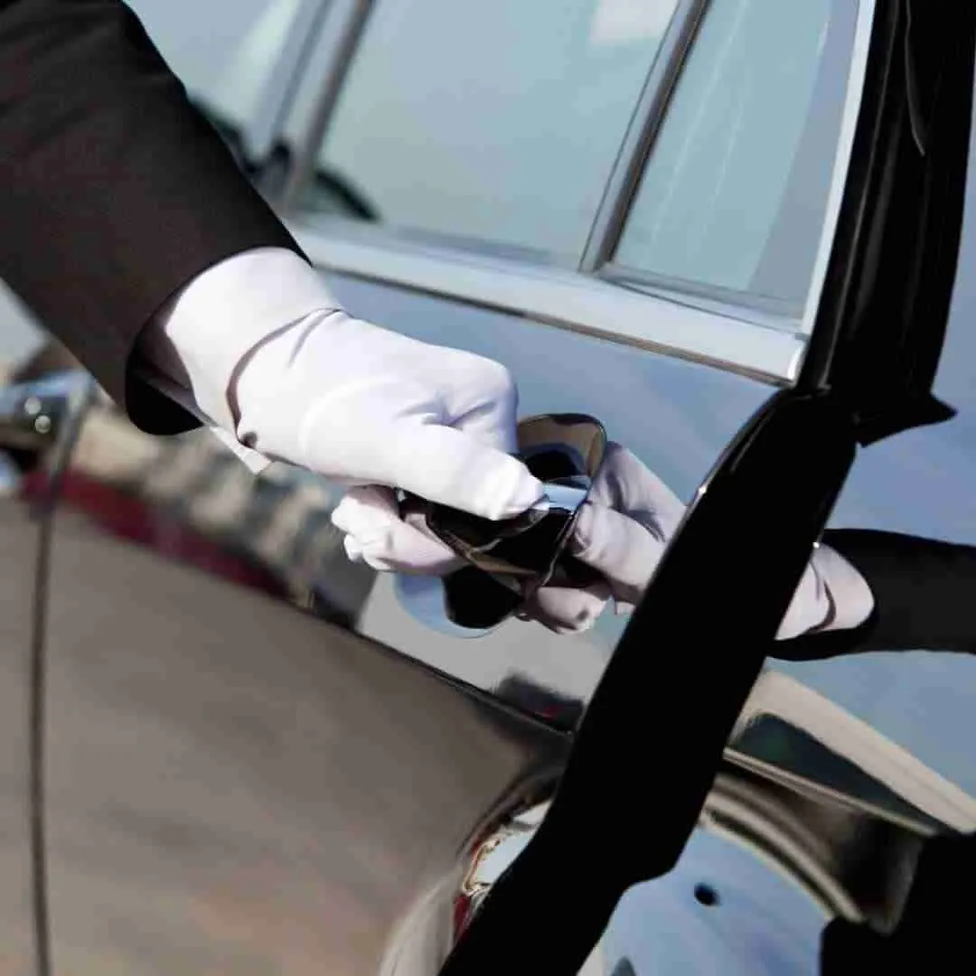 chauffeur opening door of a luxury limousine in Thailand