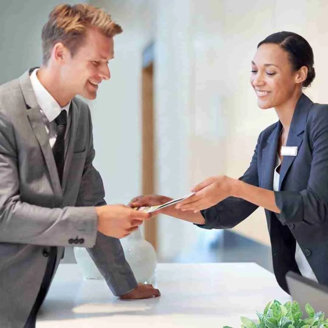 a concierge showing a document to her client