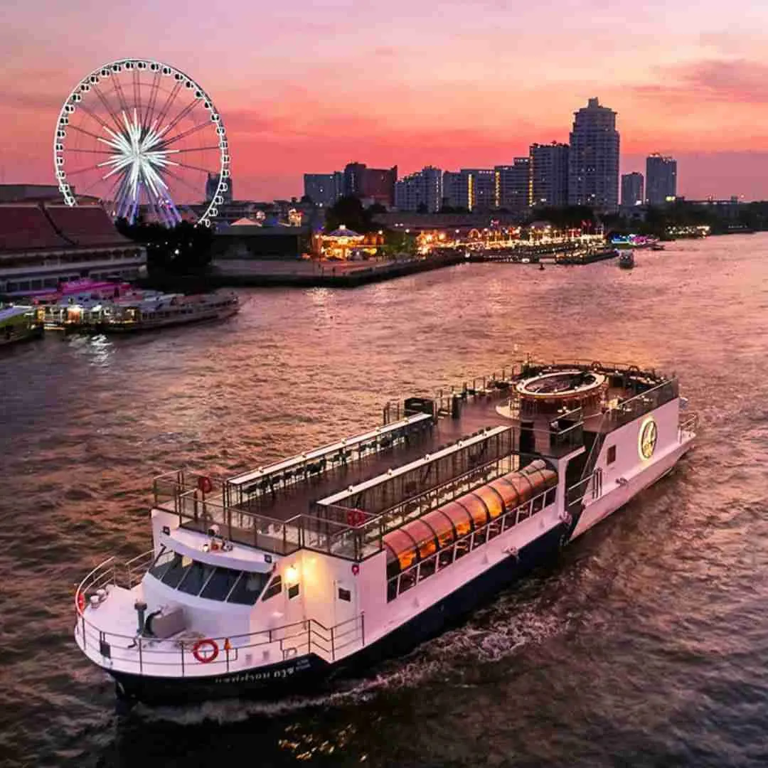 cruise boat on the Chao Phraya river at sunset in Bangkok Thailand next to Asiatique Riverfront