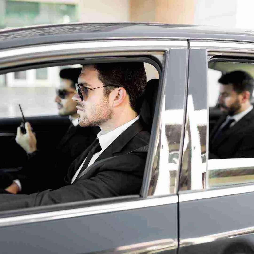 bodyguards protecting a client in a car in Thailand