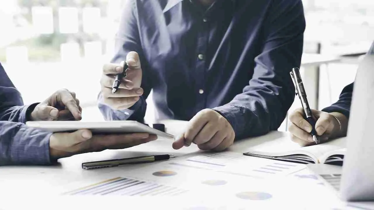 financial advisor showing documents to his clients