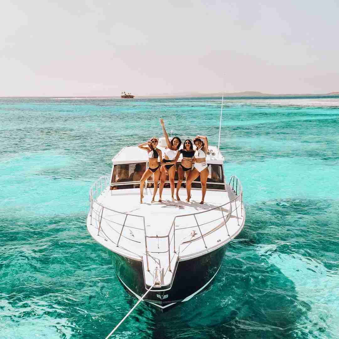 girls on a yacht party in Thailand surrounded by beautiful turquoise water