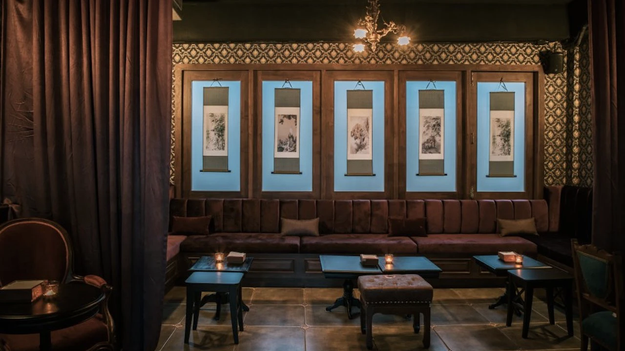 wall decoration consisting of ancient chinese paintings at honest mistake bar in bangkok