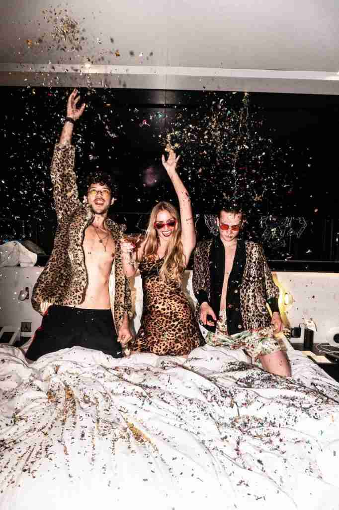 models partying in a hotel room with glitters and drinks