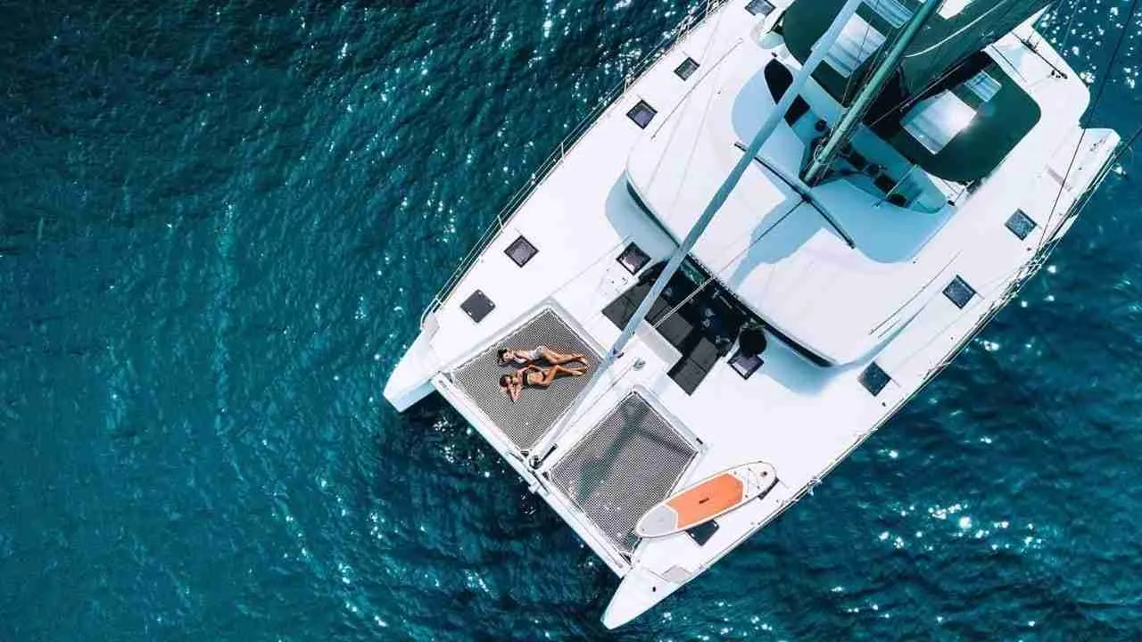 girls laying down on the deck of a luxury cruise yacht during a private tour in Thailand