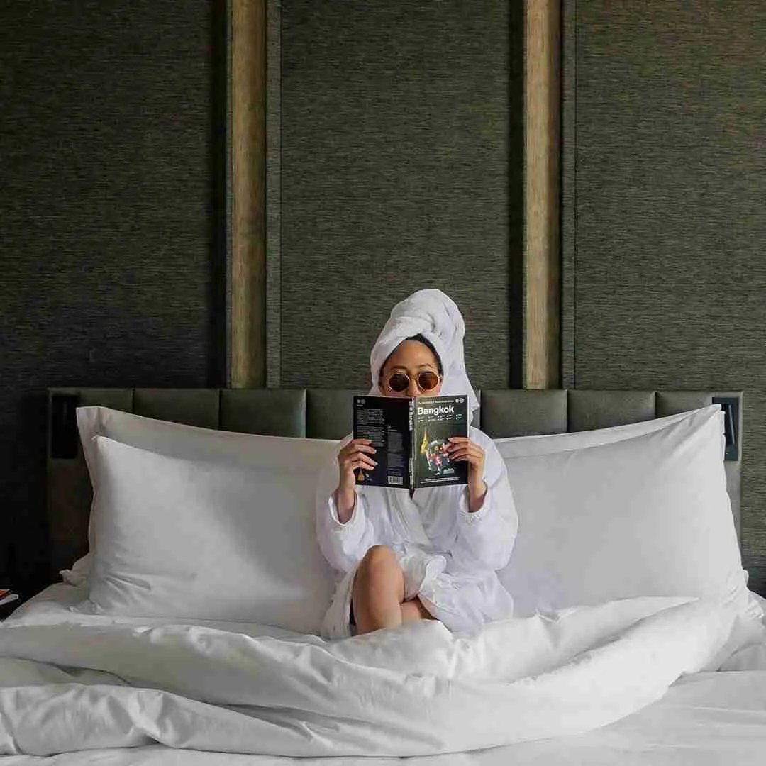 women chilling in bed in a luxury hotel in Bangkok Thailand