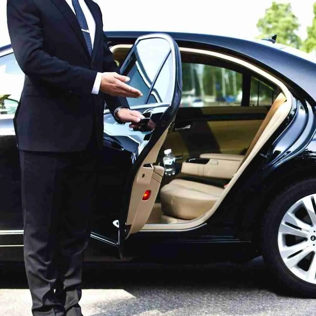 chauffeur opening the door of a luxury limousine in Thailand