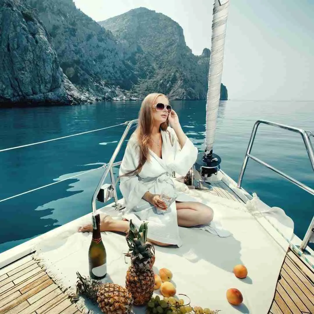 girl enjoying drinks and food on a luxury yacht in Thailand