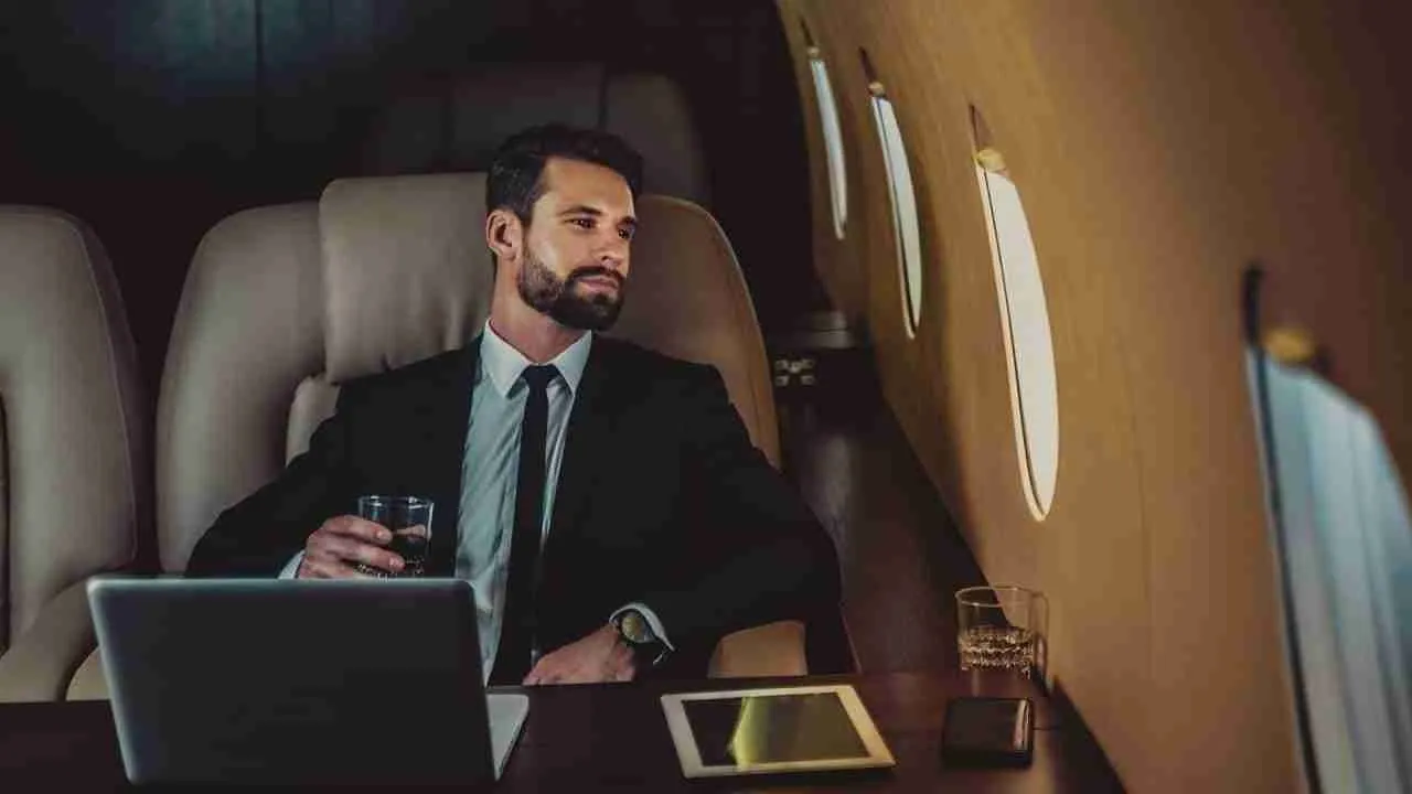 men drinking inside a private jet