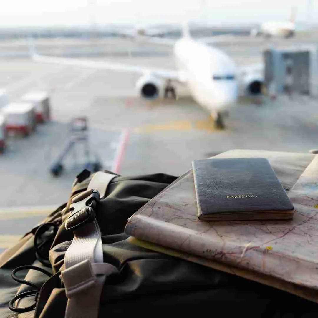 passport on a bag with an airplane in the background