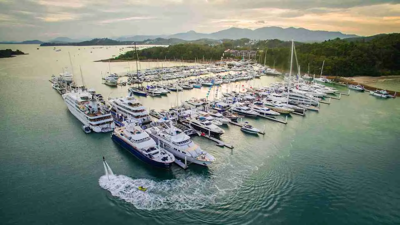 Phuket marina full of luxury yachts and superyachts during the sunset