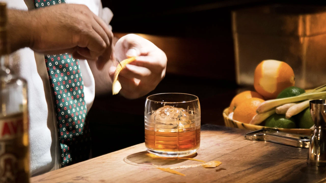 a bartender making a cocktail at q&a cocktail bar in Bangkok