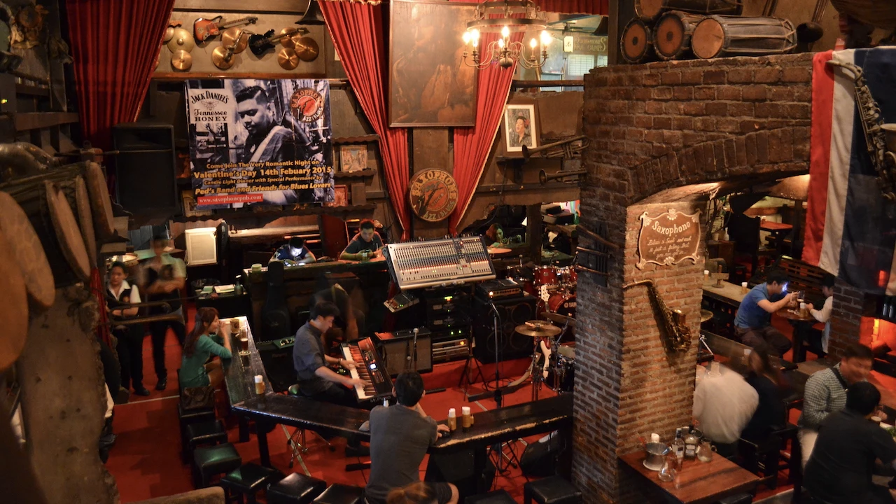 a musician plays piano during a live music performance at saxophone bar in Bangkok