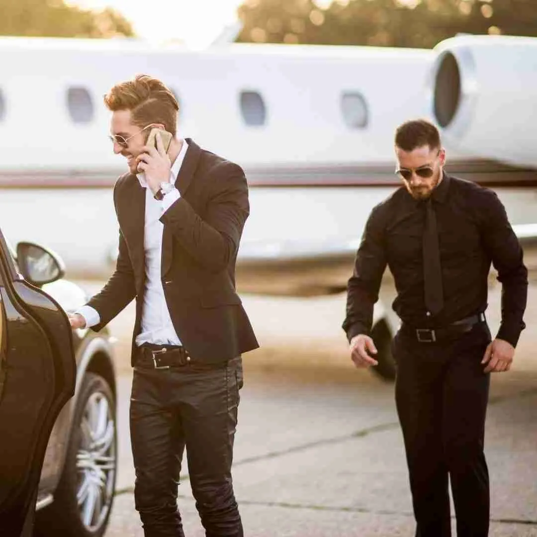 businessman with his vip security getting off a private jet