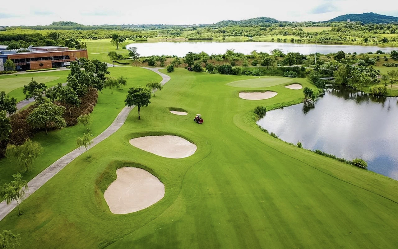 view of siam country club golf course showing a lake, and sand