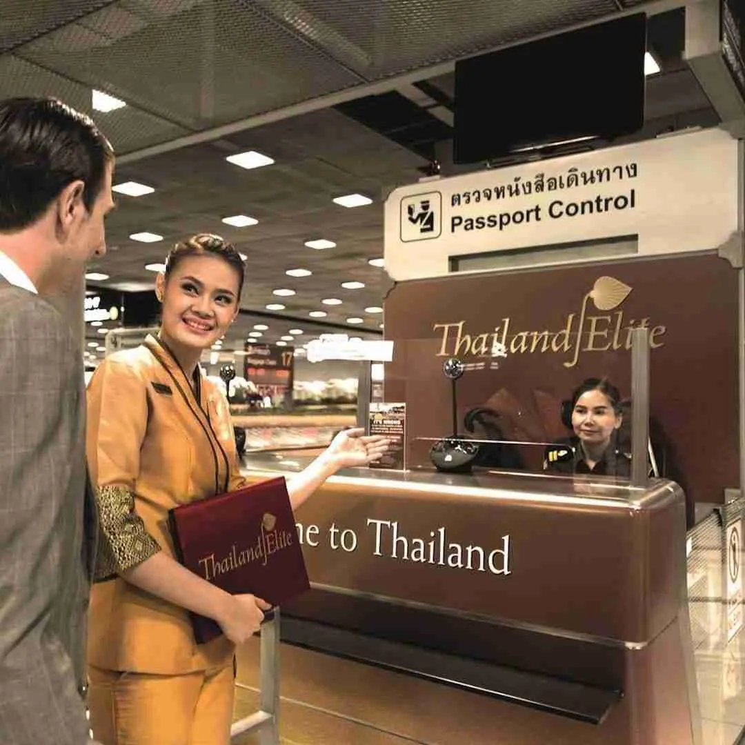 Thai hostess escorting a VIP at the immigration counter at an airport in Bangkok