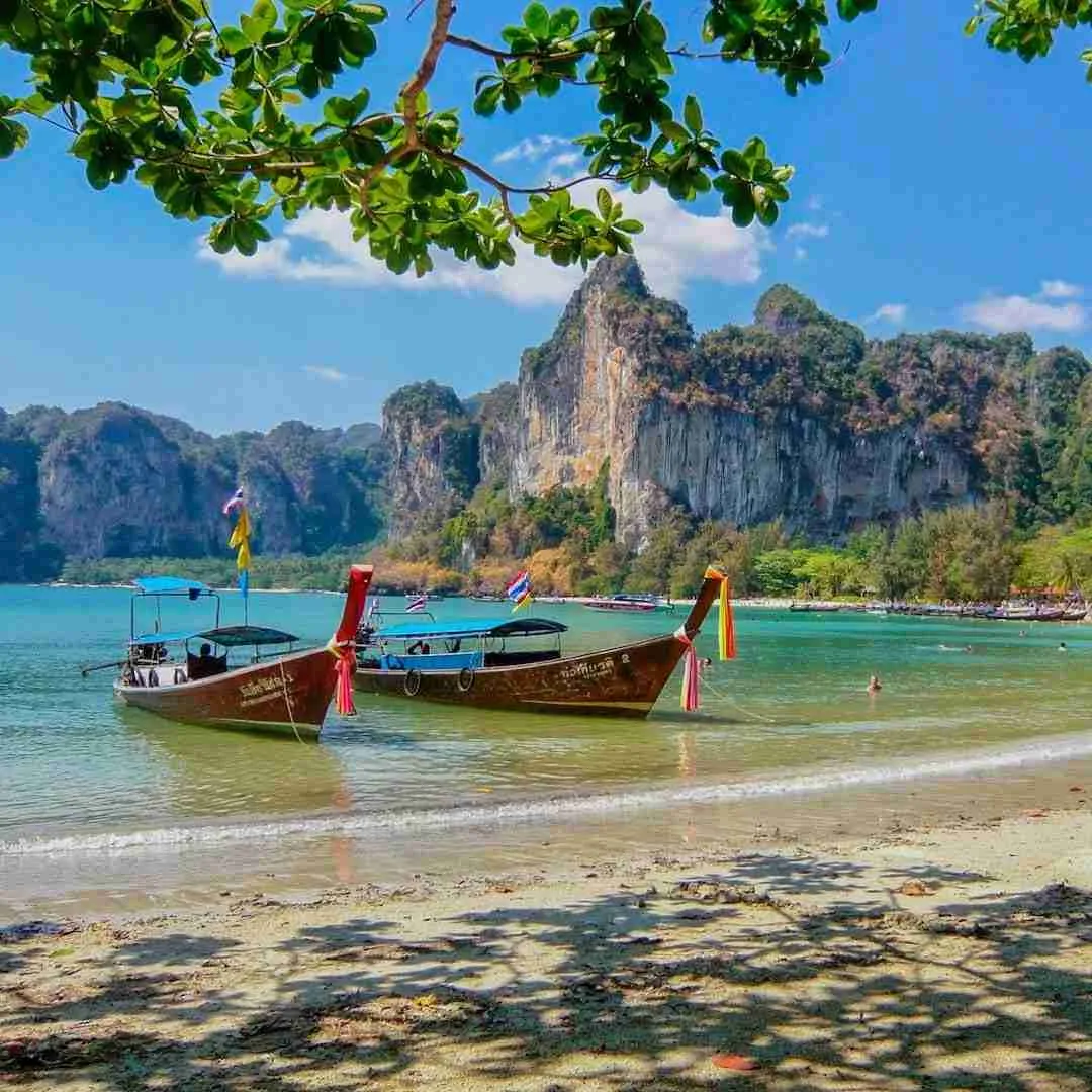 longtail boats on a beautiful beach in Thailand