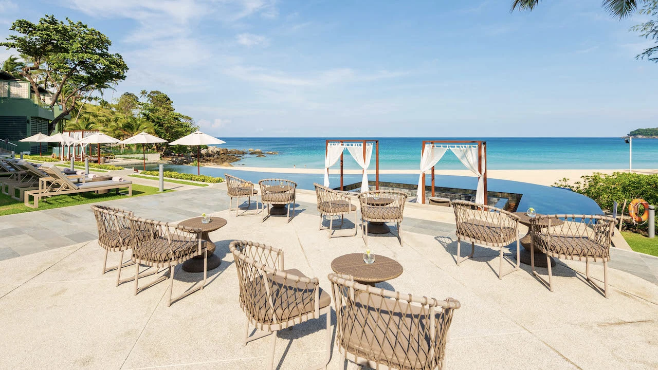 chairs and infinity pool and view of the sea at the nest beach club in phuket