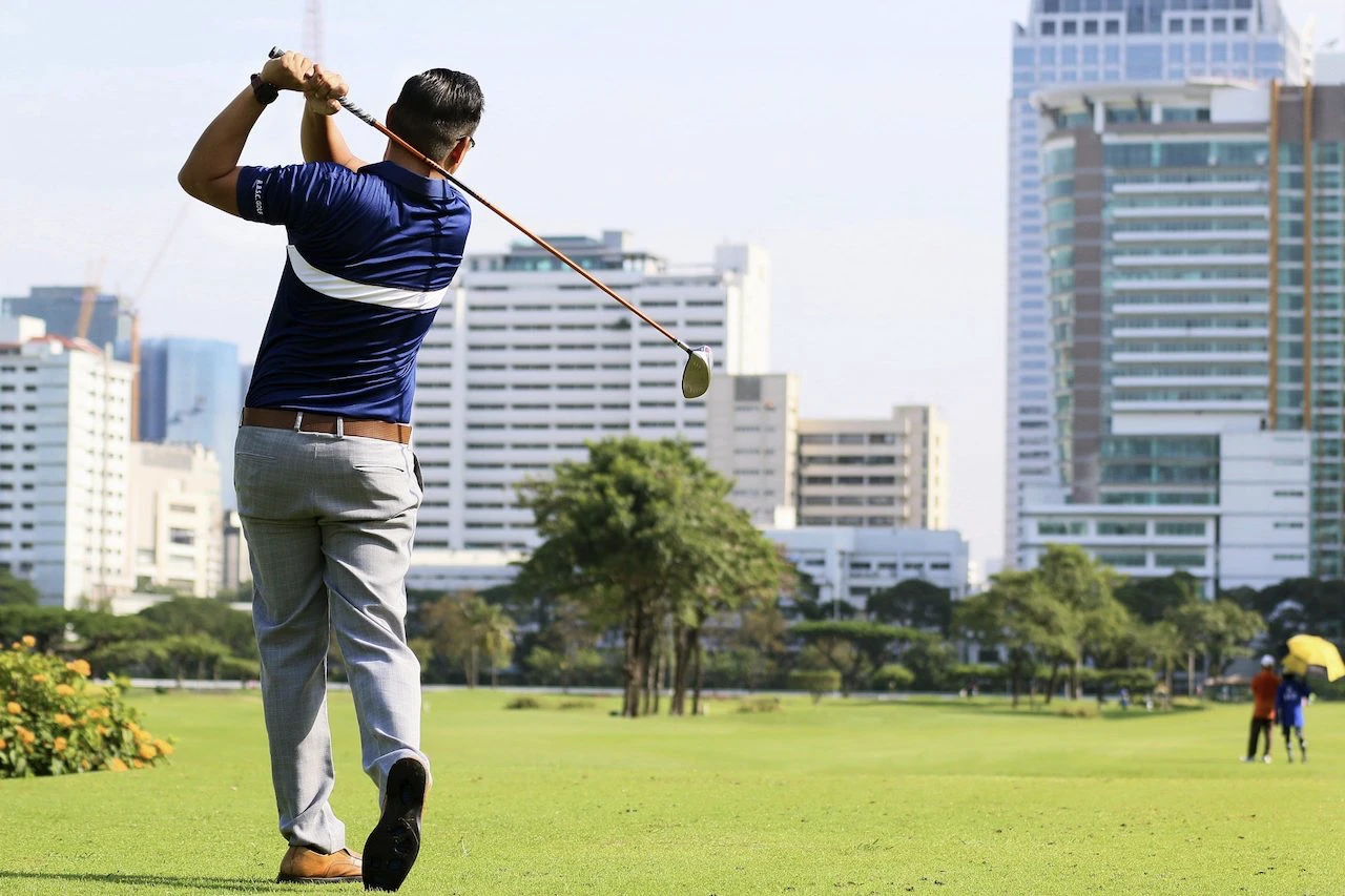 a man is playing golf at the royal bangkok sports club in the city