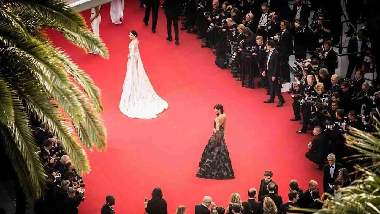 actresses with beautiful dresses walking over the red carpet at a movie premiere