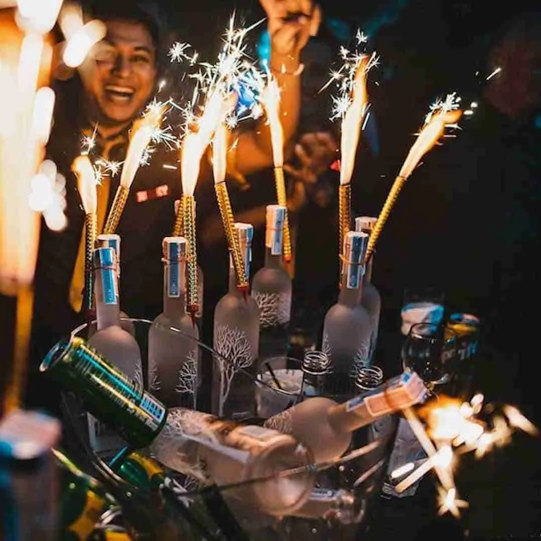 liquor bottles with sparkers at a VIP table at a club in Bangkok