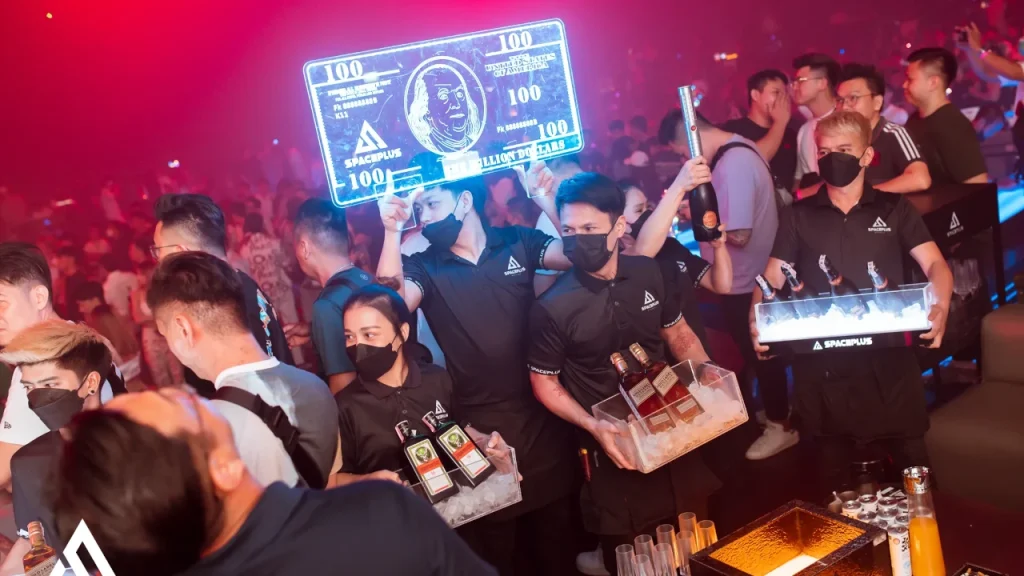 best VIP table with many bottles bottles and a neon banknote at the Spaceplus Club in Bangkok