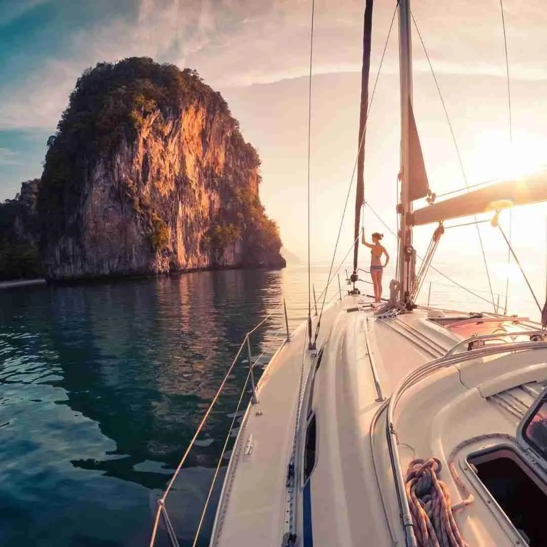 woman on a sailing boat during sunset in Thailand