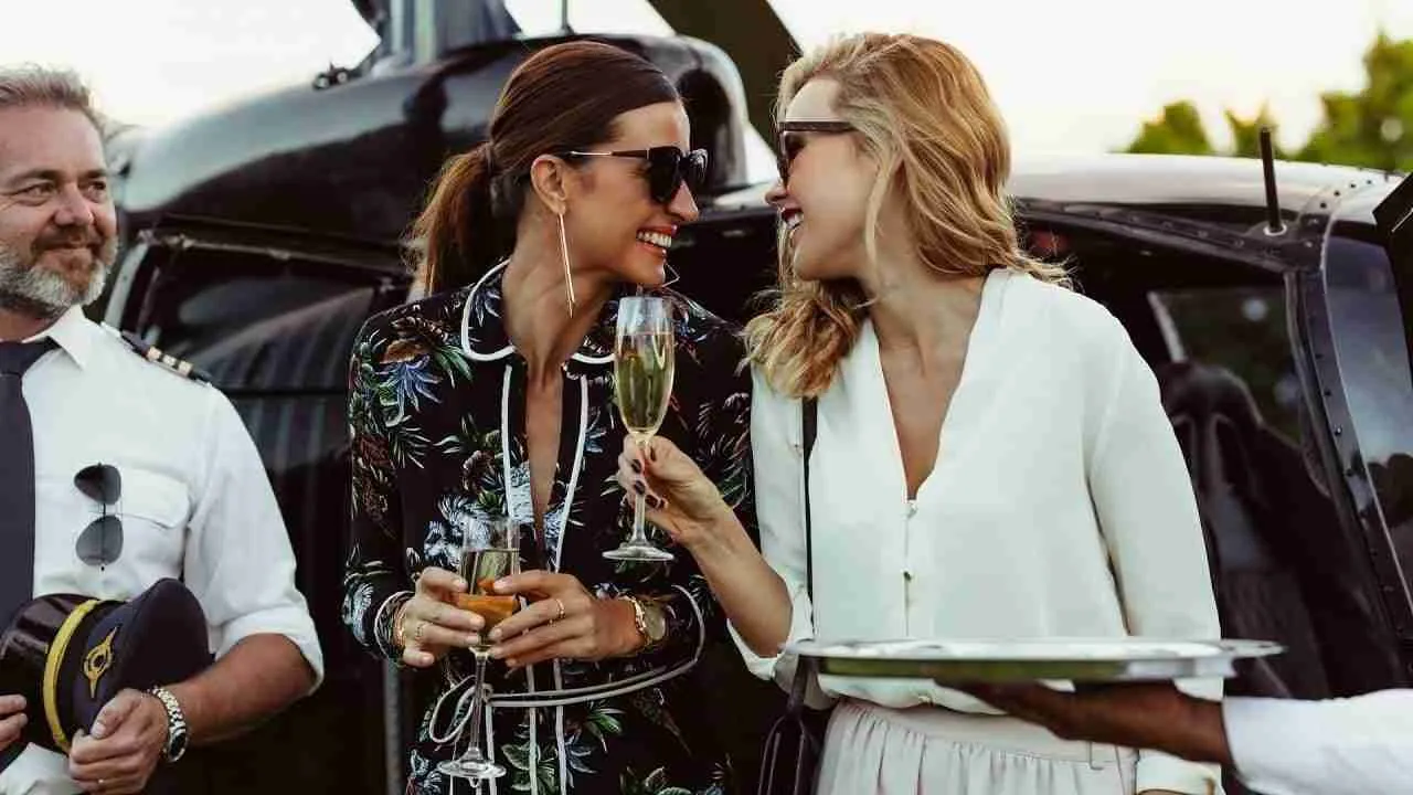 women drinking champagne after a private helicopter transfer